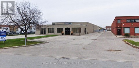 A sign in front of a building says Royal LePage Signature Realty Brokerage.