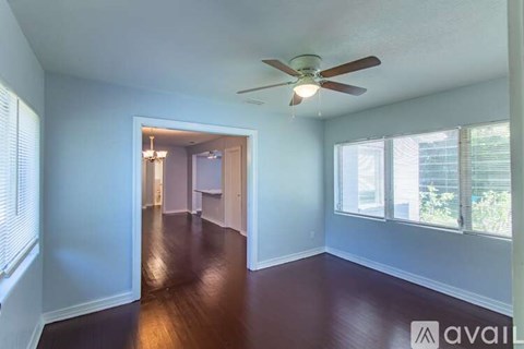 A room with a ceiling fan and a chandelier.