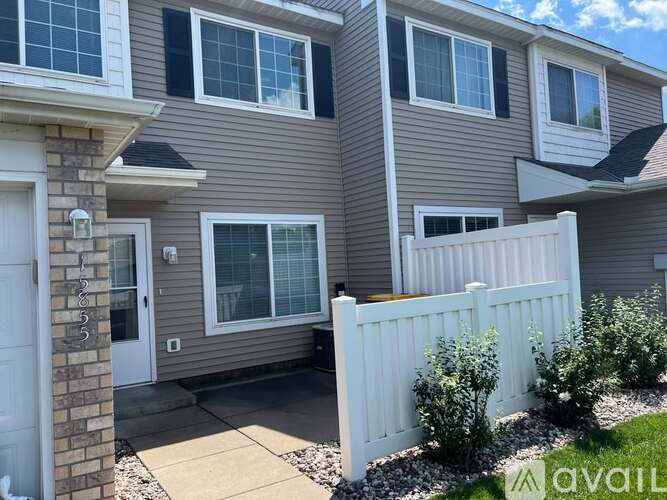 A house with a white fence and a sign that says "available".