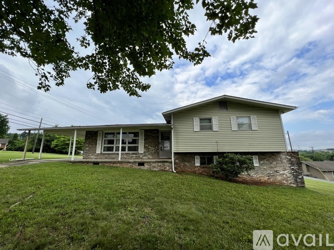 A house with a lawn in front of it is for sale.
