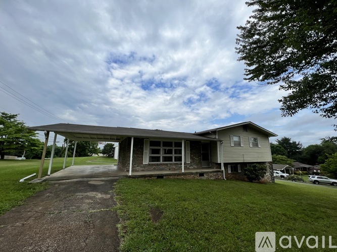 A house with a covered porch is available for sale.