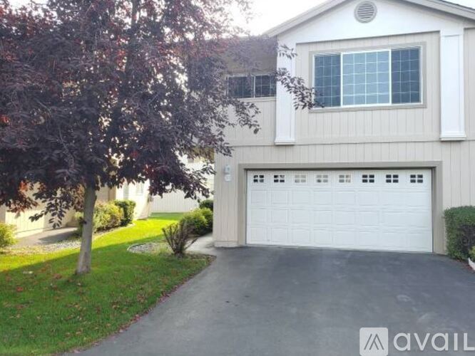 A house with a white garage door is for sale.