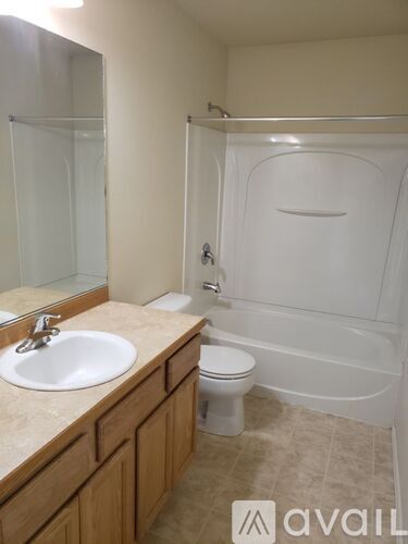 A bathroom with a sink, toilet, and bathtub.