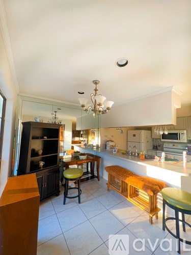 A kitchen with a table and chairs in the middle of the room.