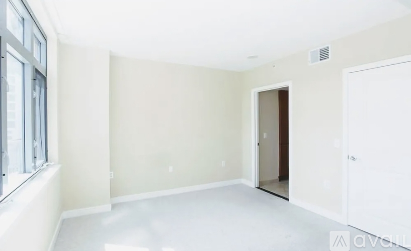 A spacious room with a door and a window.