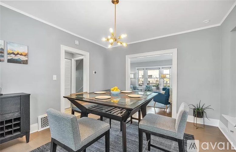 A dining room with a wooden table and chairs.