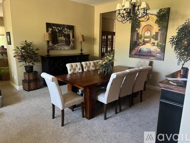 A dining room with a wooden table and chairs.