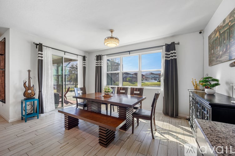 A dining room with a wooden table and chairs.