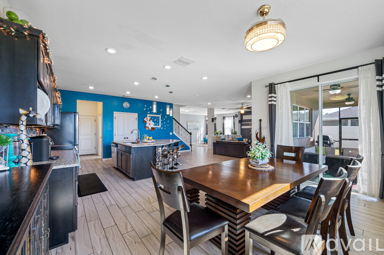 A modern kitchen with a dining table and chairs.