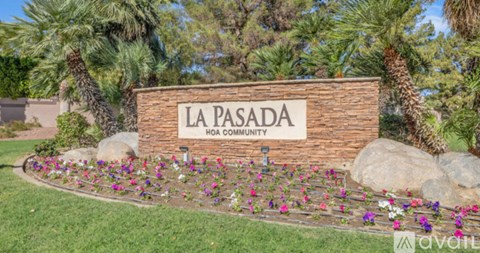 A sign that says La Pasada HOA Community in front of some trees.