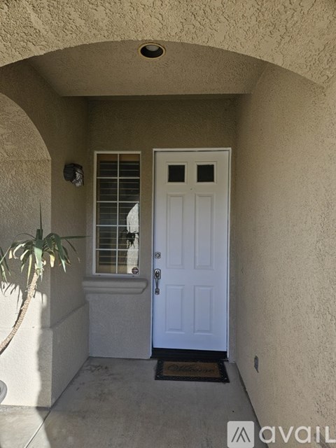 A white door is on the right side of a wall.