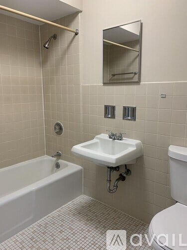 A bathroom with a white sink, toilet, and bathtub.