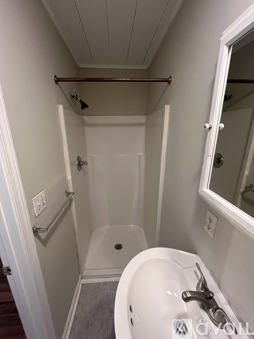 A white sink in a small bathroom.