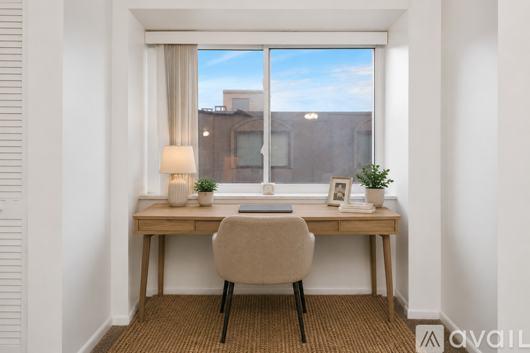 A well-lit room with a desk and chair.
