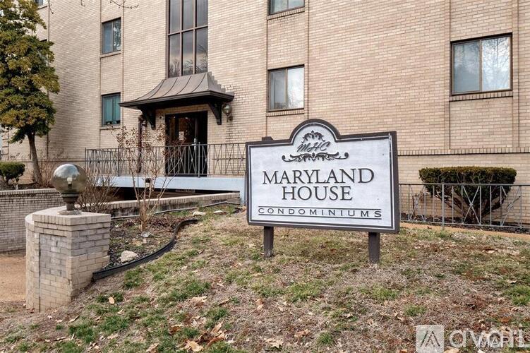 A sign in front of a building that says "Maryland House".
