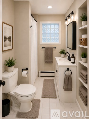 A bathroom with a toilet, sink, and mirror.