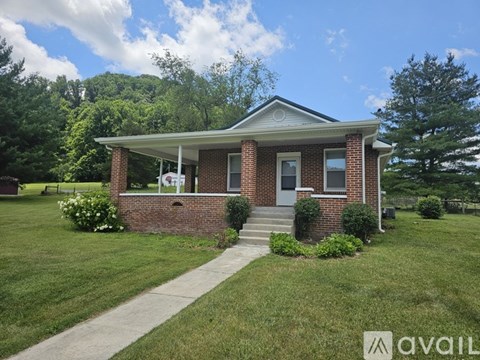 A brick house with a porch and a white door.