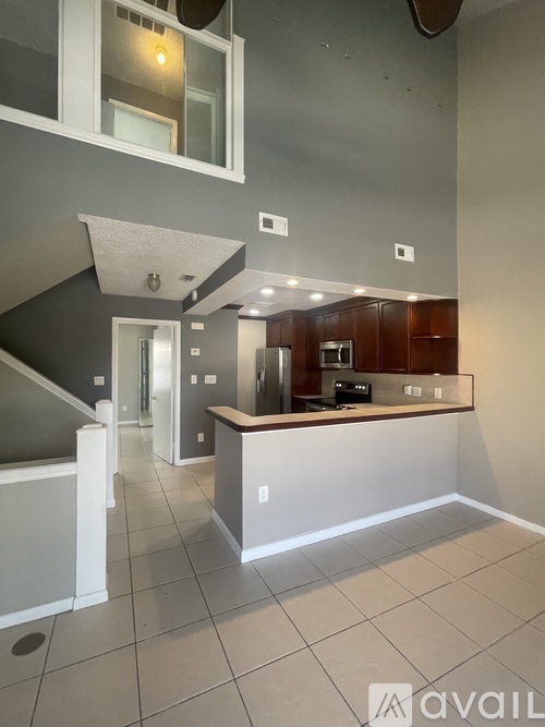 A kitchen area with a counter and cabinets.