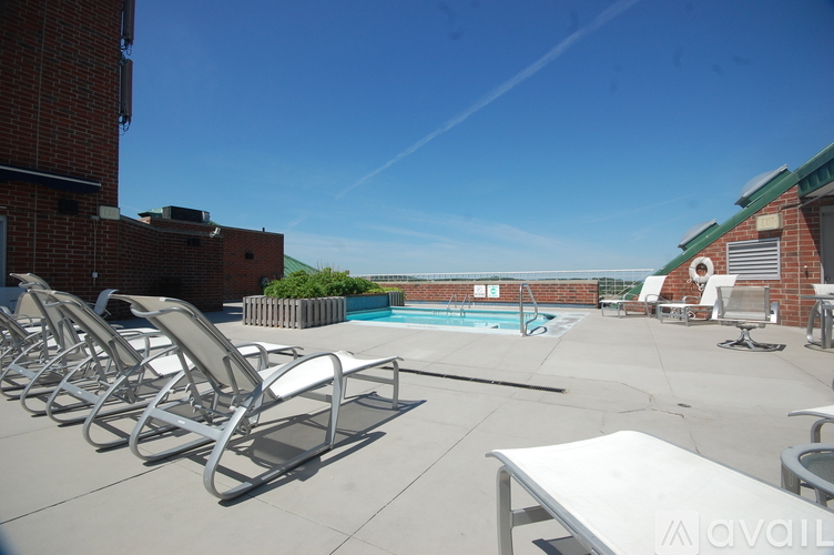 A pool area with sun loungers and a table.