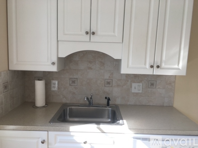 A kitchen with a sink and cabinets.