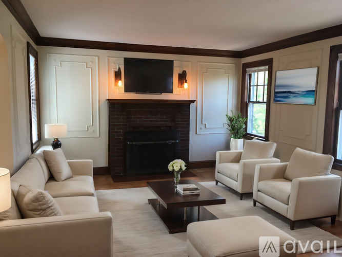 A living room with a fireplace and a flat screen TV mounted above it.