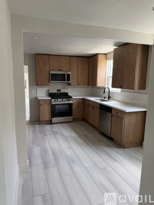 A kitchen with wooden cabinets and a white countertop.
