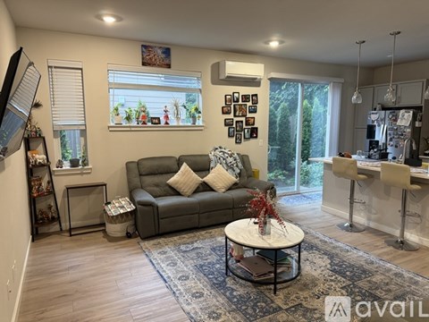 A living room with a grey couch and a coffee table.