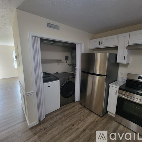 A kitchen with a stainless steel refrigerator, oven, and dishwasher.
