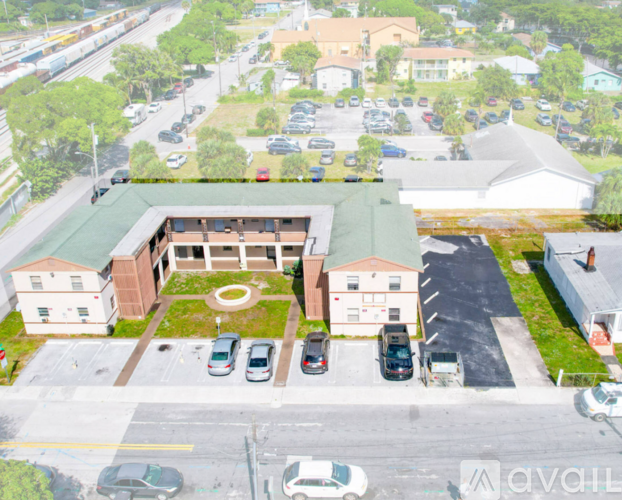A parking lot with cars and a building in the background.