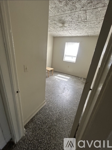 A room with a window and a table in it.