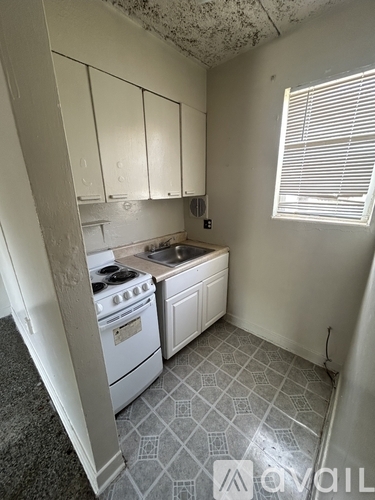 A kitchen with a stove and a sink.