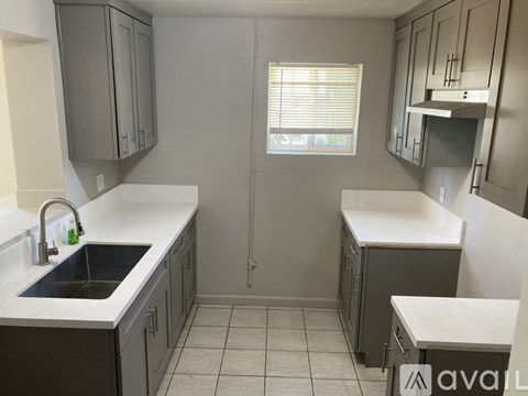 A kitchen with a sink and a window.