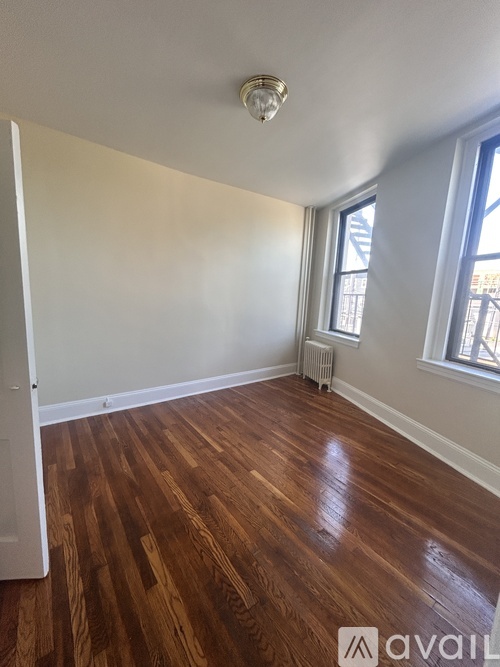 A room with wooden floors and a window.