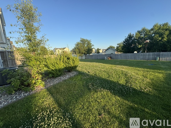 A backyard with a gravel path and a grassy area.