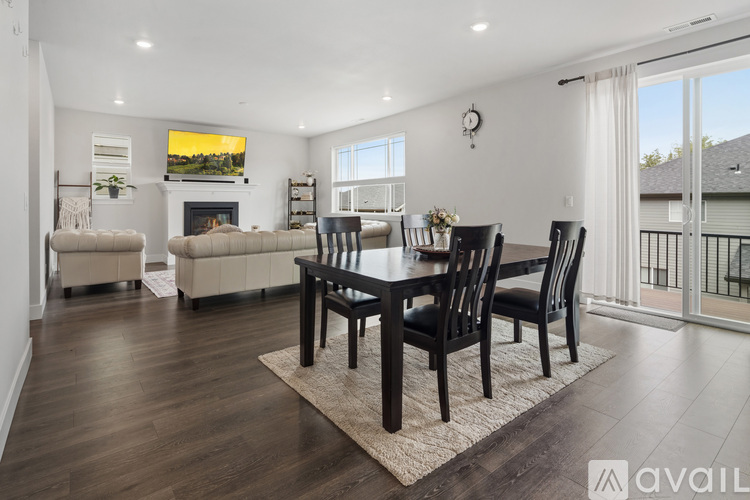 A modern living room with a fireplace and a dining table set up.