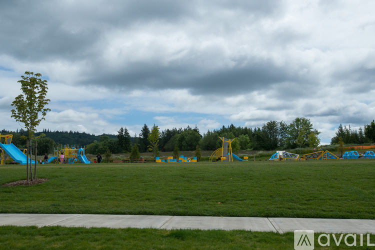 A playground with a blue slide and a yellow structure.