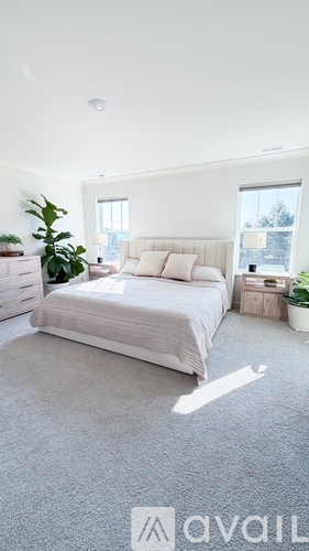 A bedroom with a large bed and a window overlooking a snowy landscape.