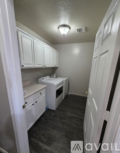 A small white kitchen with a sink and a microwave.