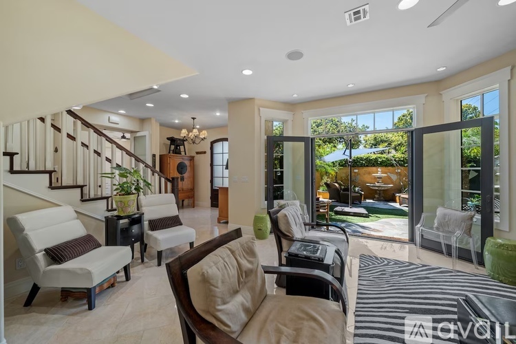A living room with a striped rug and a couch.
