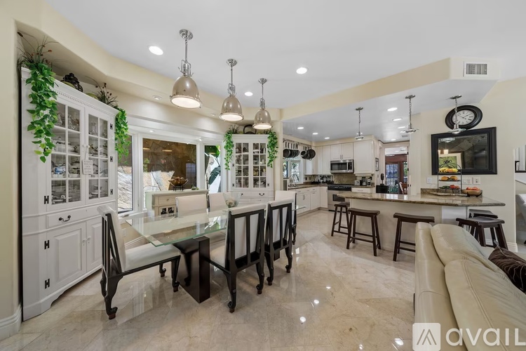 A modern kitchen with a dining table and chairs.