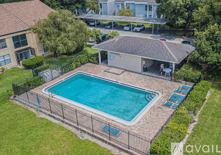 An aerial view of a house with a blue swimming pool.