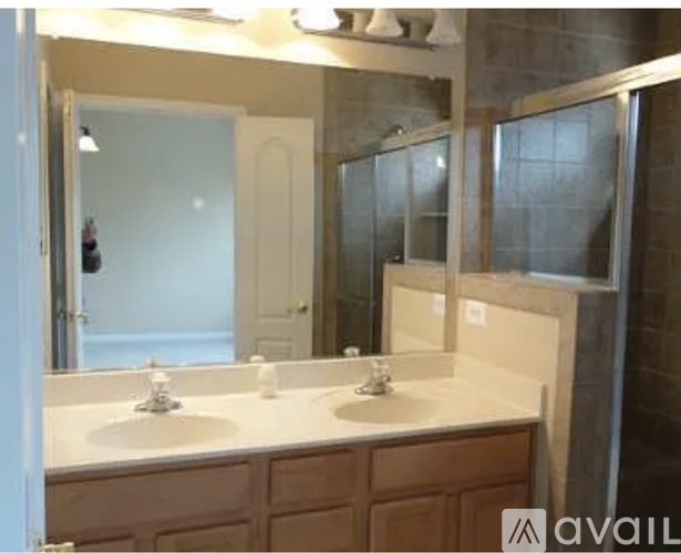 A bathroom with two sinks and a large mirror.