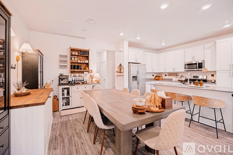 A modern kitchen with a dining table set for two.