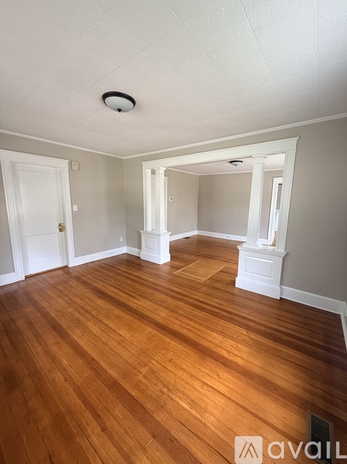 A room with wooden floors and white walls.