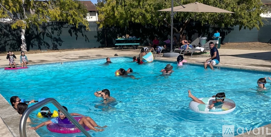 People are enjoying a sunny day at the pool.