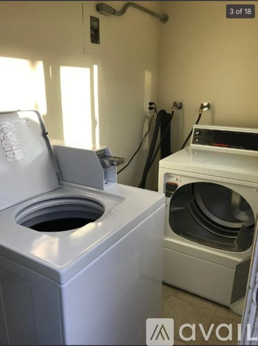 A white washing machine and dryer in a laundry room.