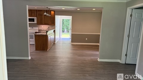A kitchen with wooden cabinets and a countertop is visible.