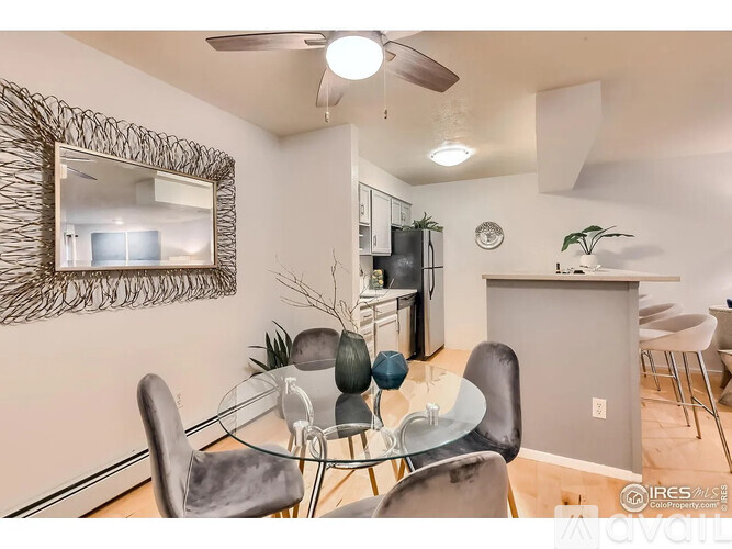 A modern dining room with a glass table and chairs.