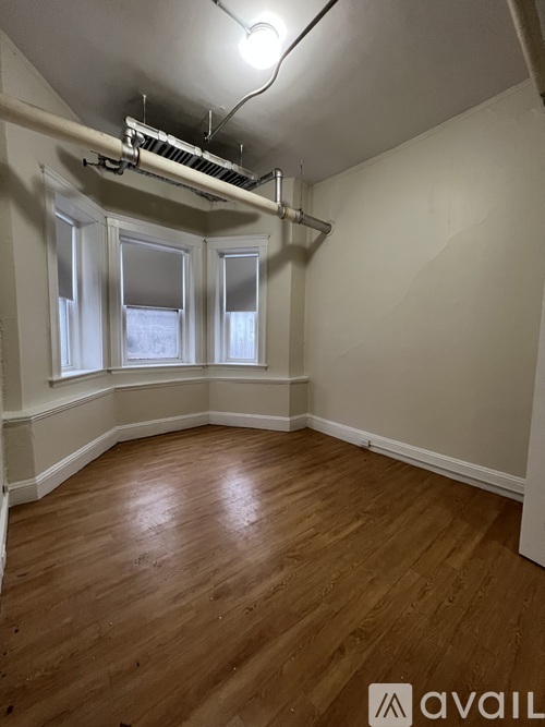 A room with wooden floors and white walls.