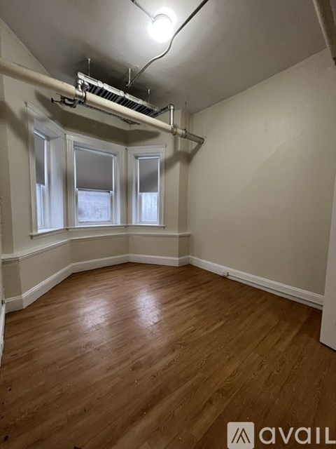 A room with wooden floors and white walls.